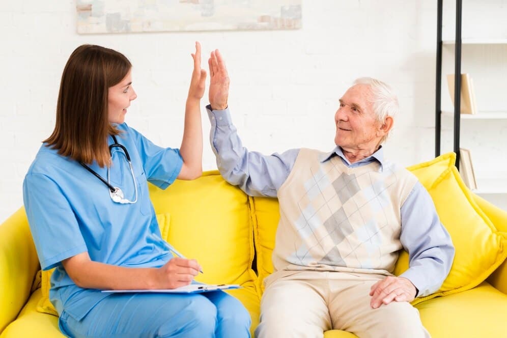 Elderly person receiving care from healthcare professional